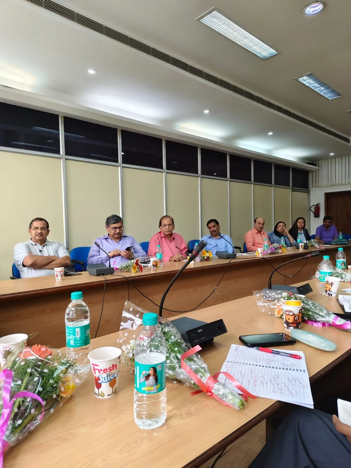 Committee members seated around a conference table