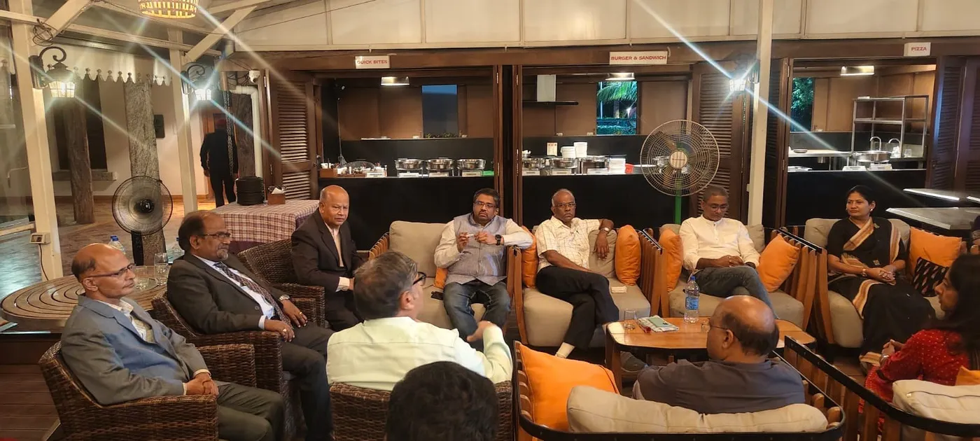 Members seated together at an evening networking meet